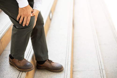 Knee hurting when you're going down stairs? One of these issues could be the reason why shutterstock 1860296830 knee hurts when going down stairs
