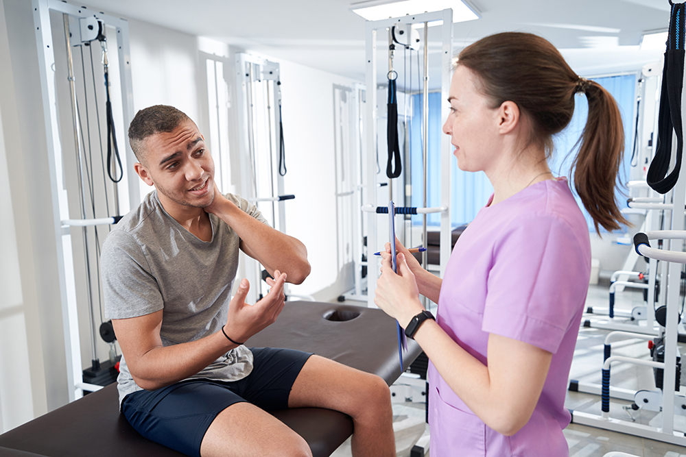 Does physical therapy work? The science behind the treatment african american man talking with doctor in physic 2022 09 01 02 15 39 utc 1 african american man talking with doctor in physical therapy clinic