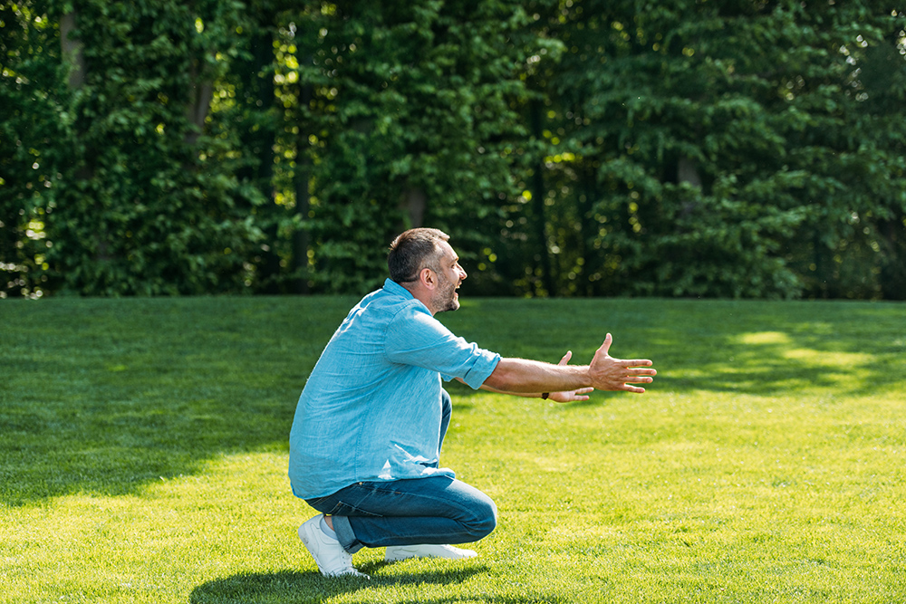 Can you kneel after knee replacement? side view of happy man with open arms crouching an 2023 11 27 05 35 03 utc can you kneel after knee replacement? knee pain
